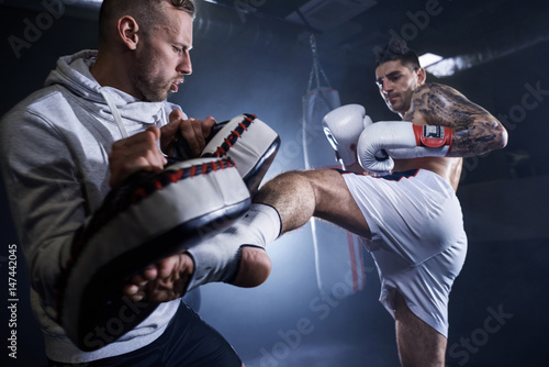 Canvas Print Young athlete doing self defense training .