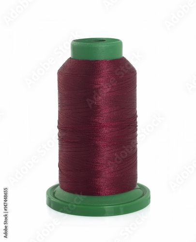 Burgundy spool of thread isolated on white background