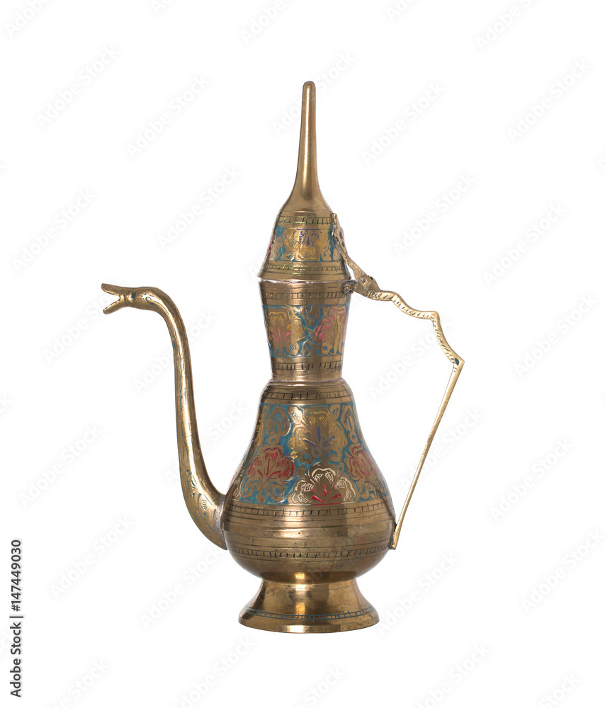 Copper jug with a traditional Arabic ornaments on a white background Copper jug with a traditional Arabic ornaments on a white background