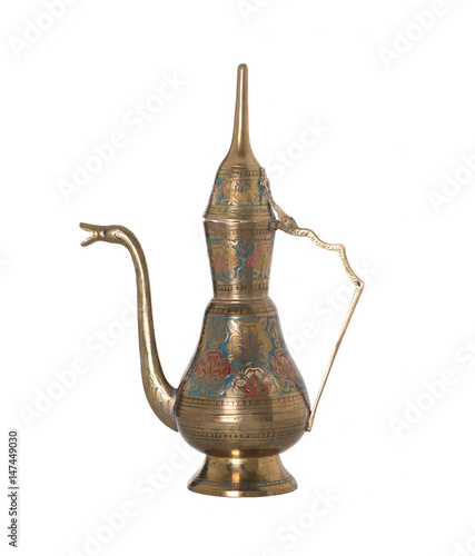 Copper jug with a traditional Arabic ornaments on a white background