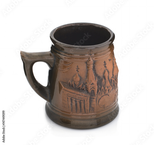 Mug with a handle of red clay on a white background