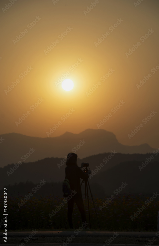 Silhouette woman photographer at sunset, person taking a photo landscape at the high moutain. Silhouette woman photographer at sunset, person taking a photo landscape at the high moutain.