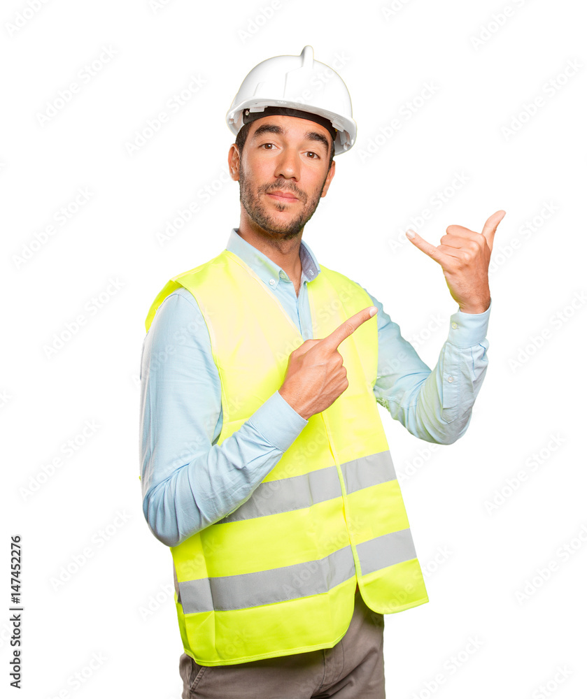 Happy engineer with call gesture against white background Happy engineer with call gesture against white background