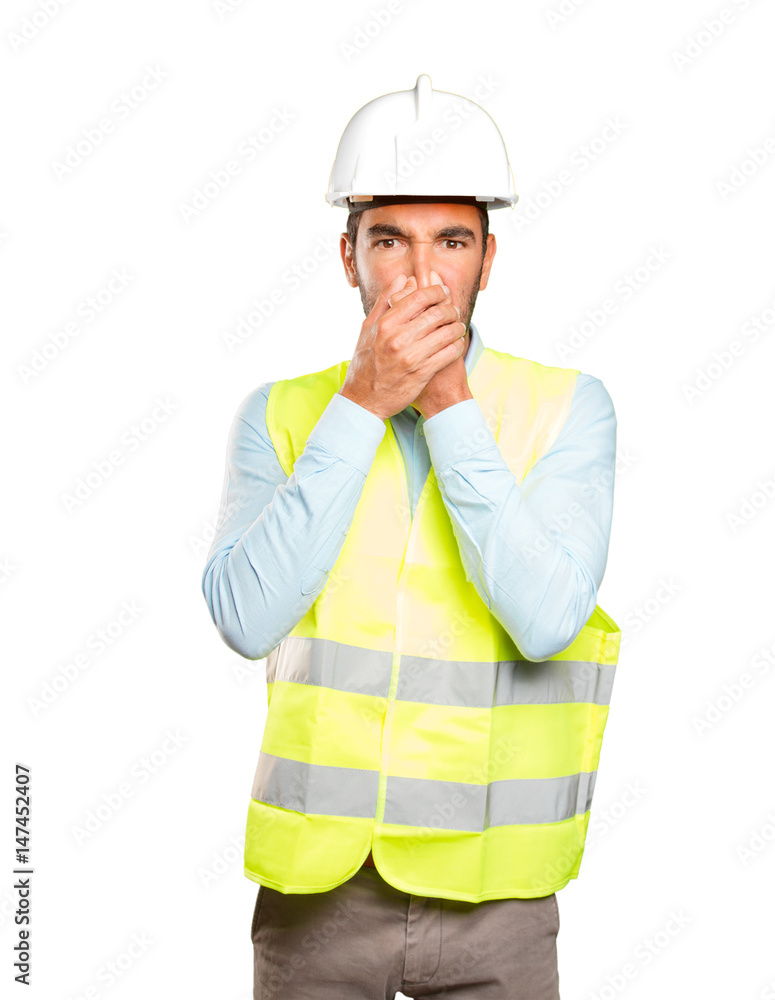 Worried engineer with bad smell gesture against white background Worried engineer with bad smell gesture against white background