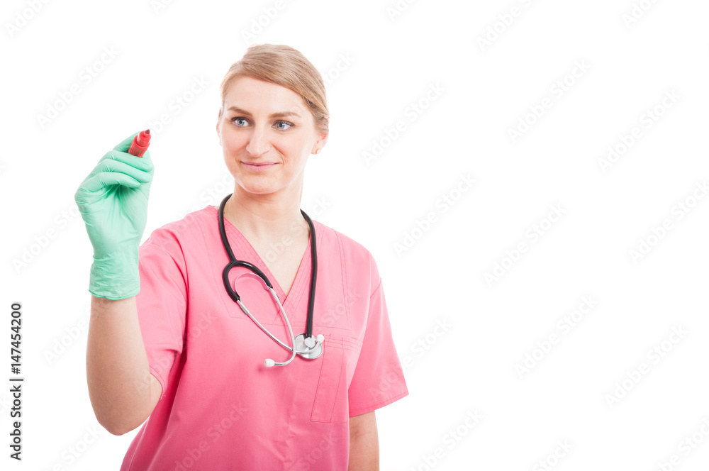 Friendly medical nurse lady writing on invisible board Friendly medical nurse lady writing on invisible board
