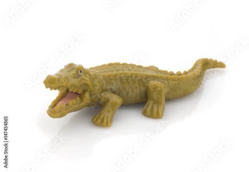 Green plastic crocodile on a white background. Isolated