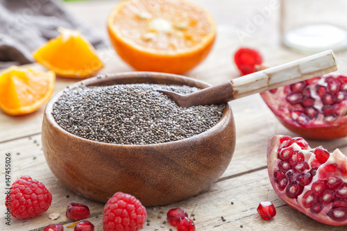 Chia seeds in a bowl on a worn out wooden table photo