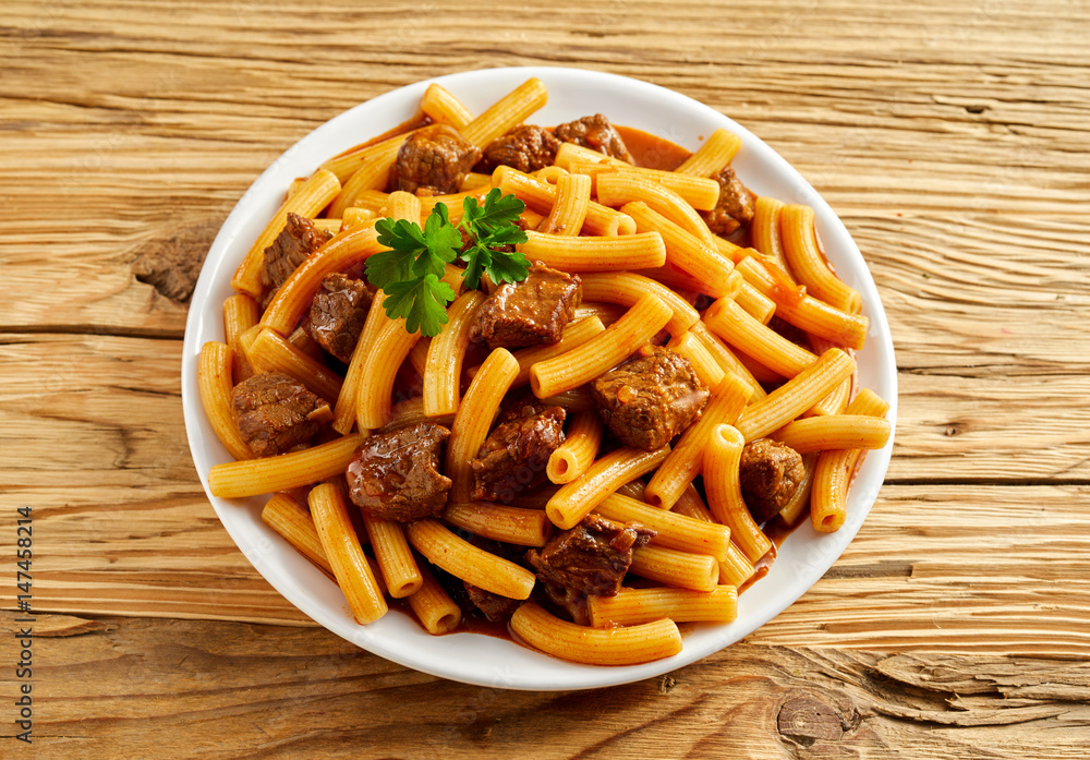 Plate of Italian rigatoni pasta with sauce Plate of Italian rigatoni pasta with sauce