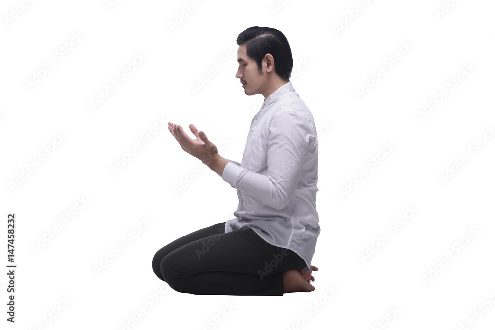 Religious asian muslim man sitting while praying Religious asian muslim man sitting while praying