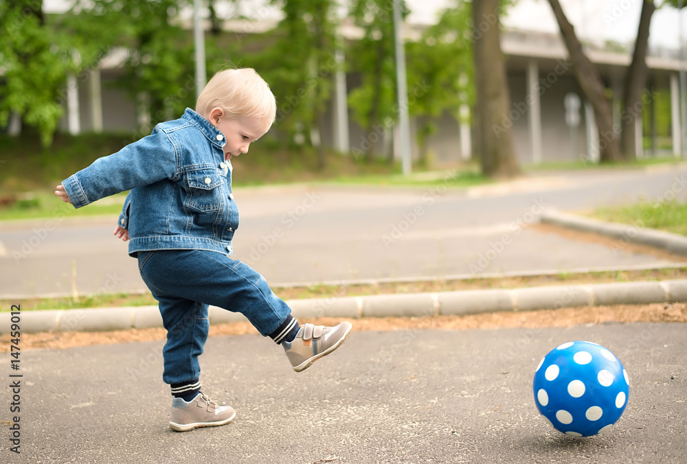 Fototapeta premium Happy kid playing football