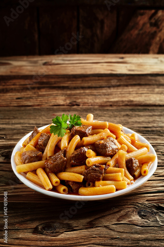 Beef rigatoni noodles on a rustic wood counter