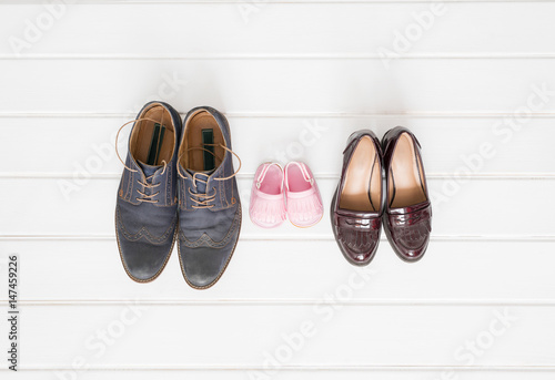 Woman's, man's, and children shoes on white background