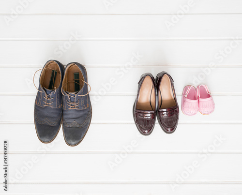 Males, females and children shoes setup on white background