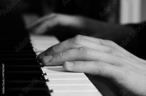 Male hands playing the piano photo