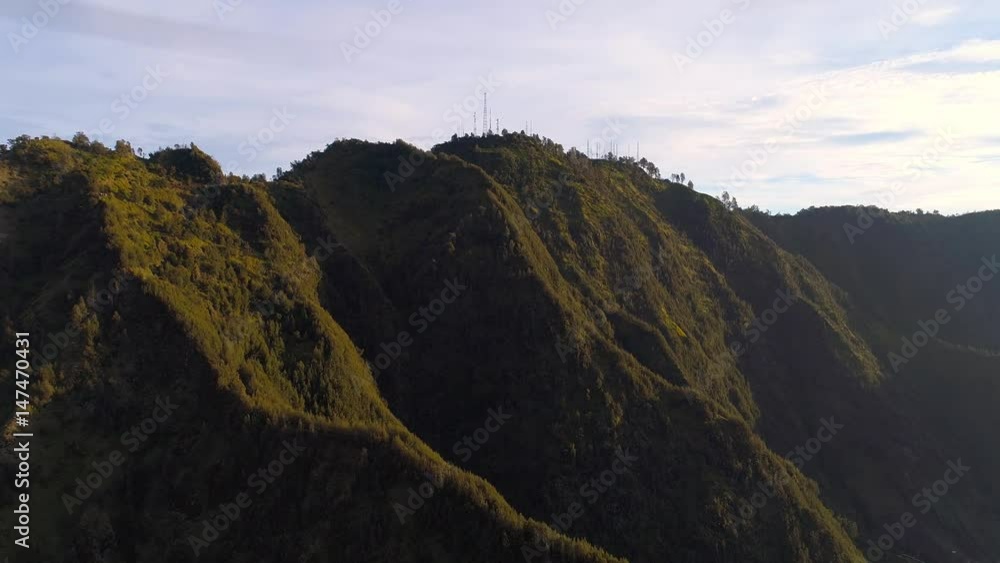 Aerial view flight over Cemoro Lawang, small village in morning mist. Which situated on the edge of massive north-east of Mount Bromo, East Java, Indonesia