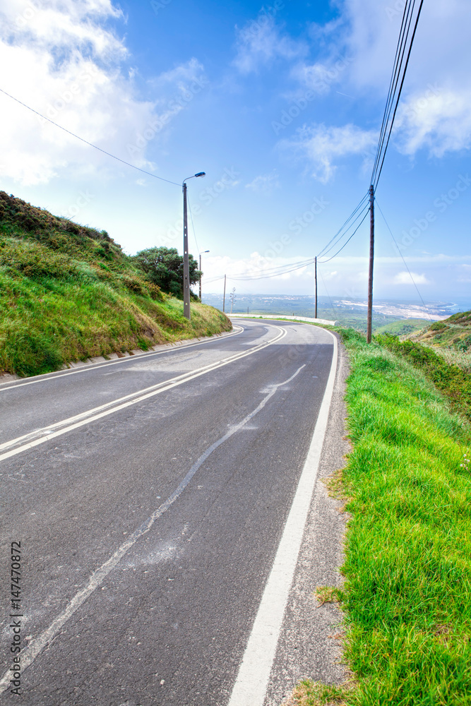 Asphalt road . Clouds on blue sky in summer day Asphalt road . Clouds on blue sky in summer day