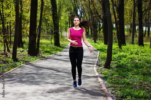 Young pretty fit woman jogging in the park. © Vadym
