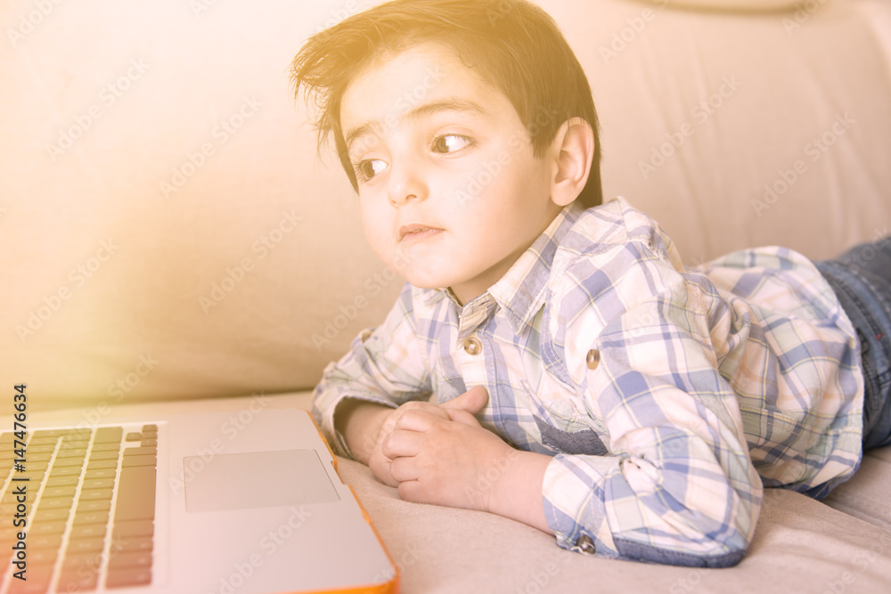Little boy surfing on his laptop Little boy surfing on his laptop