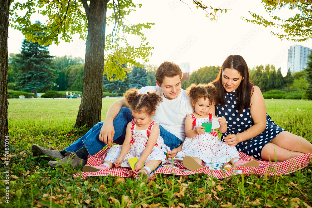 Fototapeta premium Mother, father and two ducks play in developing games nature