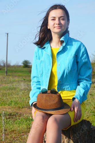 A beautiful young woman on the field in summer photo