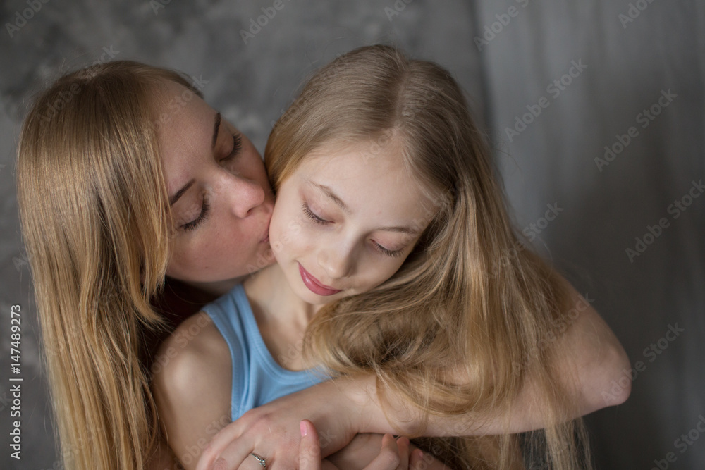 Mom and teenager embrace, concept motherhood Mom and teenager embrace, concept motherhood