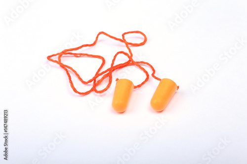Orange earplug for work. Earplug to reduce noise on a white background .