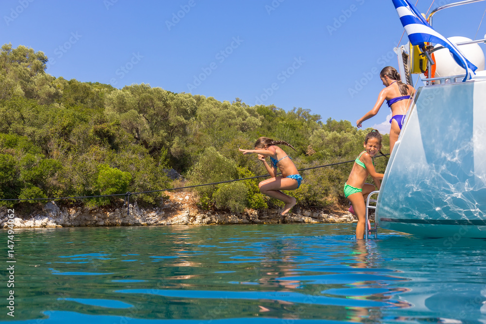 Children jumping from the sailboat