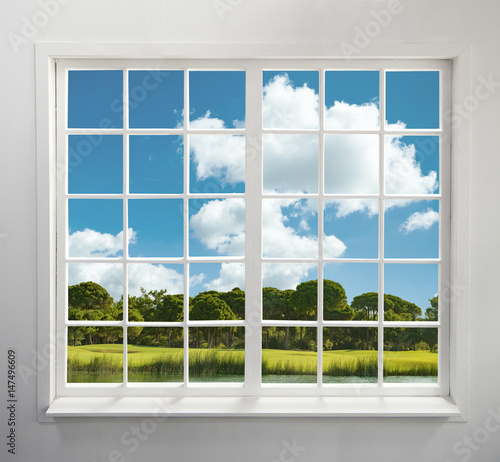 Modern residential window with lake and forest view