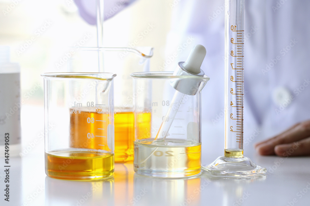 Oil pouring, Equipment and science experiments, Formulating the chemical for medicine, Organic pharmaceutical, Alternative medicine concept. (Selective Focus) Oil pouring, Equipment and science experiments, Formulating the chemical for medicine, Organic pharmaceutical, Alternative medicine concept. (Selective Focus)