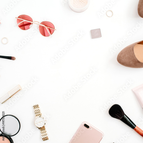 Beauty blog fashion frame concept. Female pink styled accessories: mobile phone, watches, sunglasses, cosmetics, shoes on white background. Flat lay, top view trendy feminine background.