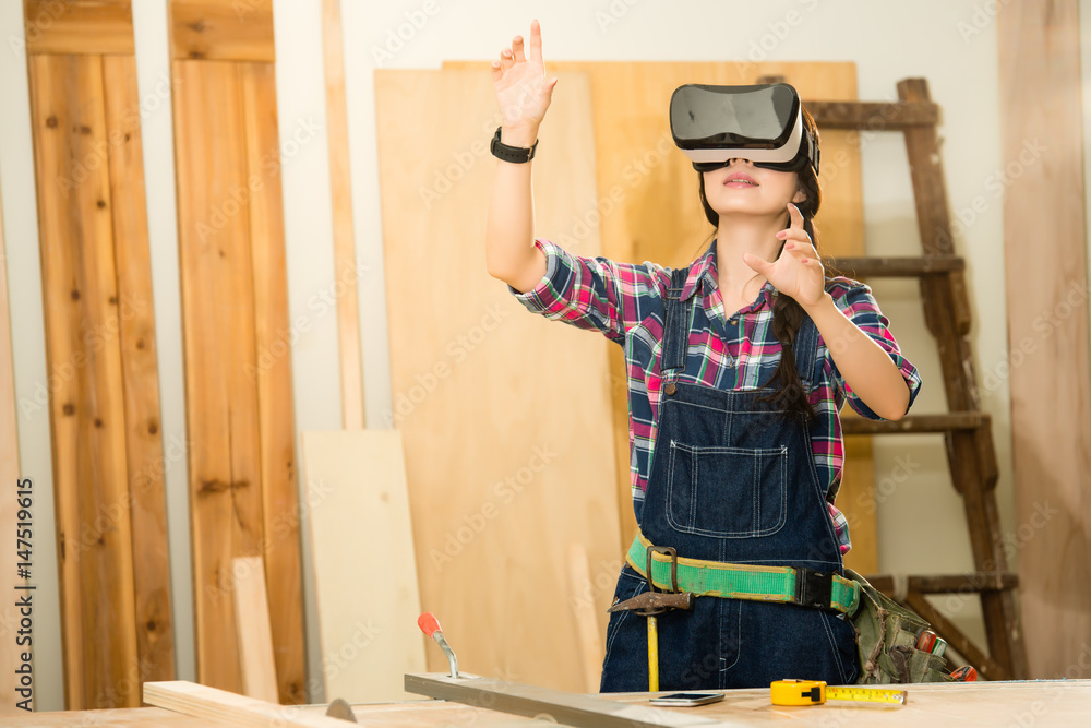Carpenter working with vr headset device Carpenter working with vr headset device