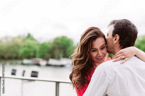 Couple kissing on riverside © Nena