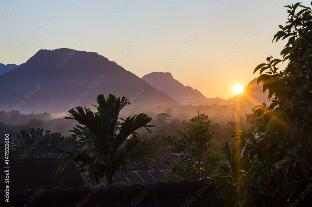 Tropical sunset landscape with mountains on the background in Vang Vieng, Laos