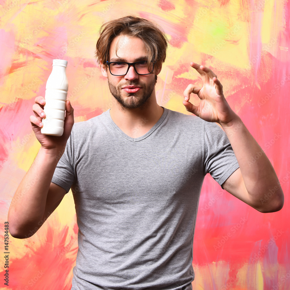 Caucasian bearded sexy macho man holding bottle of milk