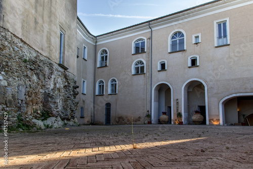 Castellabate ancient Castle (Cilento, Italy): view of courtyard at sunset, closeup on a ray of light.