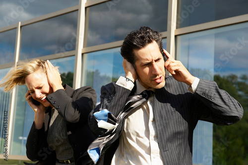 Business people with phones in wind photo