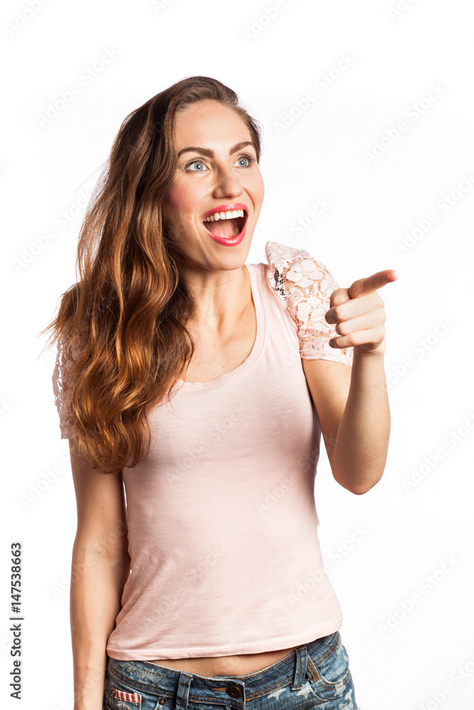 Astonished woman pointing at the copy space Astonished woman pointing at the copy space