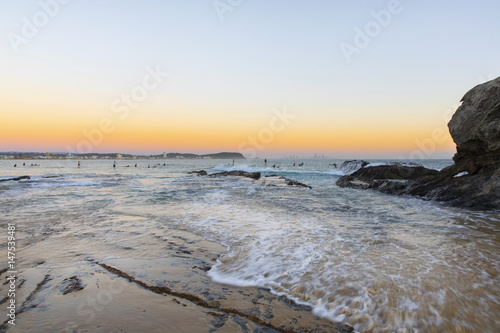 Ocean tide coming in over the rock at Currumbin Rock Gold Coast during sunrise.
