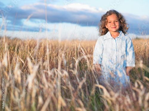 Girl standing in a field photo