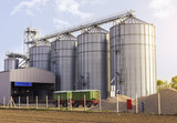 Agricultural silos for grain crops / grain silos (wheat, corn, soy, etc). Trailers park in front of facility 