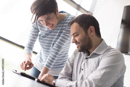 Two Business People Working With Tablet in startup office