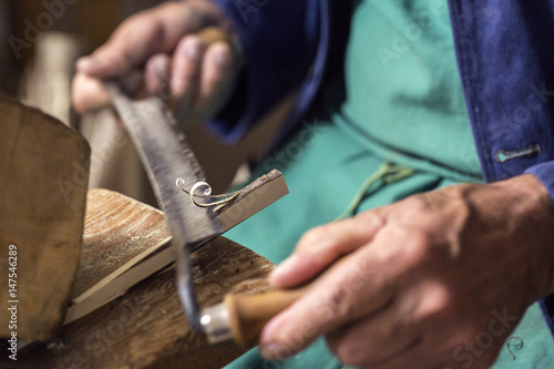 Craftsman at work in the dolomites village, Villabassa, South Tyrol, Italy