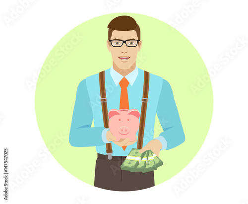 Businessman with cash money holding a piggy bank