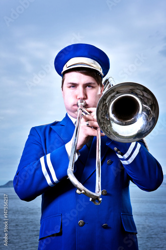 Portrait of young man playing trombone