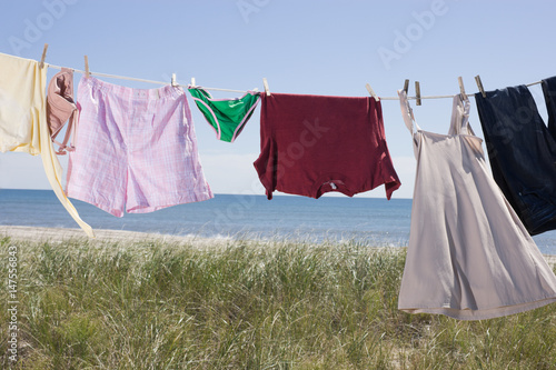 Laundry drying on clothes line by sea