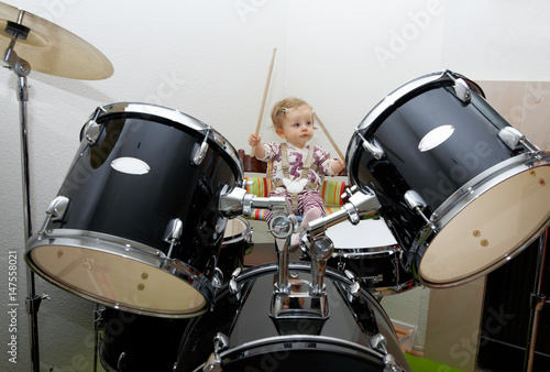 Baby girl playing drums photo