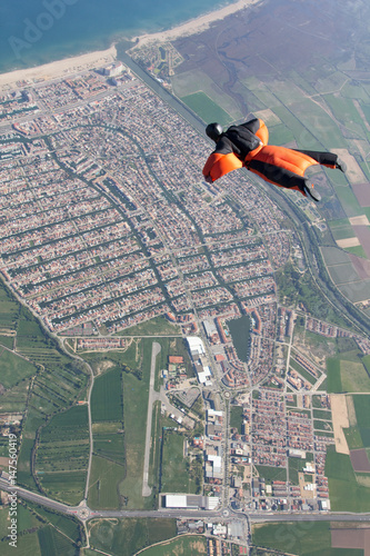 Man wingsuit flying over Empuriabrava, Spain photo