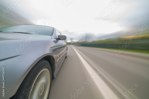 Front side view of black car with heavy blurred motion.