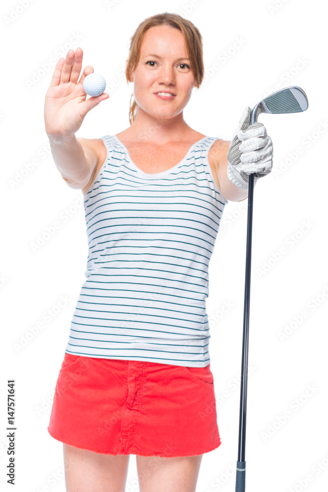 Woman golfer showing a ball and a golf club, props in focus Woman golfer showing a ball and a golf club, props in focus