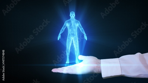 Businessman is holding a human hologram in his hand photo